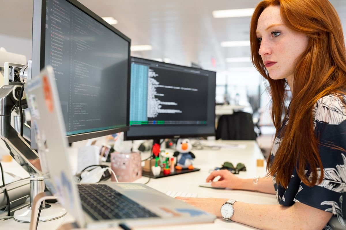RadArch engineer developing AI software on dual monitors